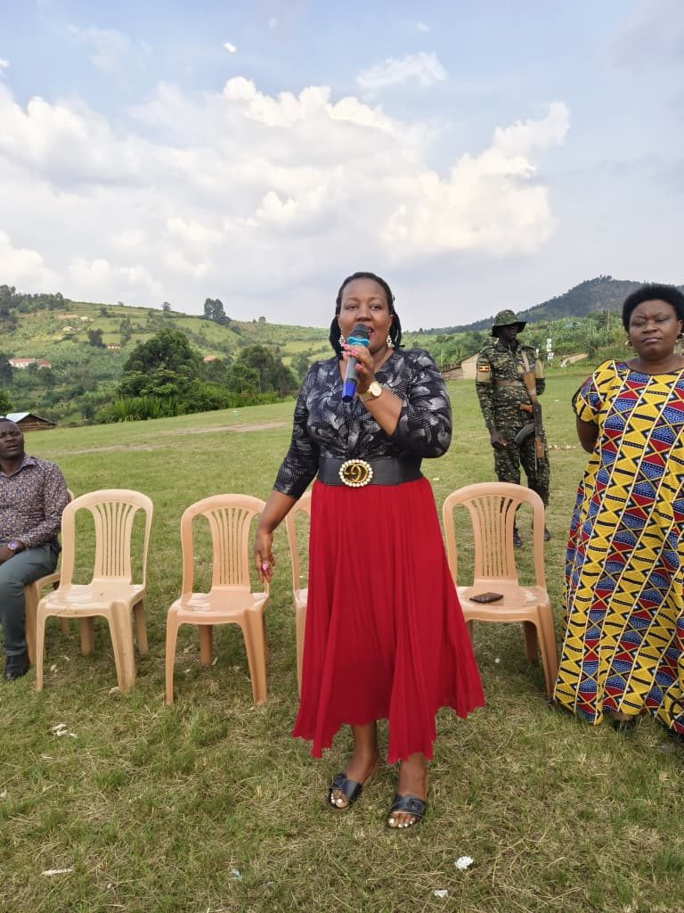 A trainer addresses a community gathering outdoors