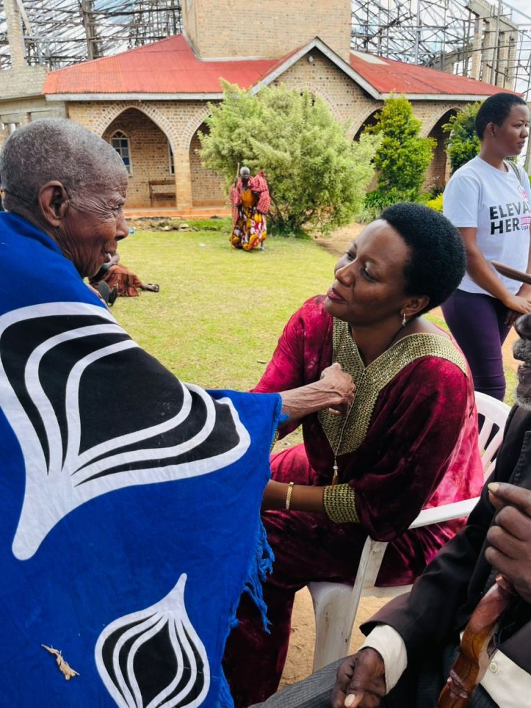 An elderly woman receives a bedcover