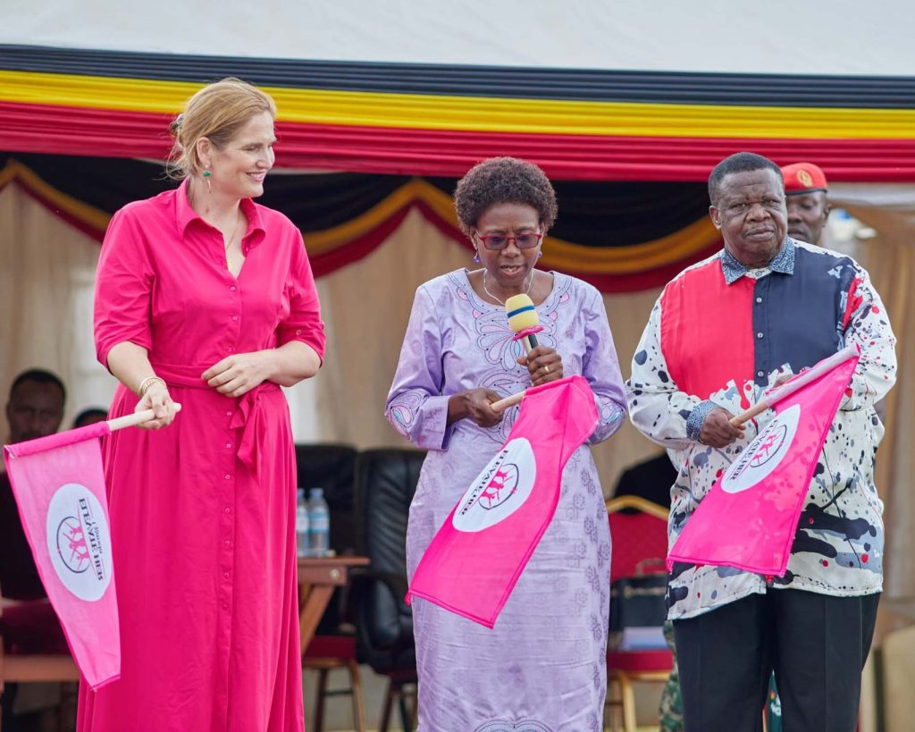 Guests raise Elevate Her flags at the launch