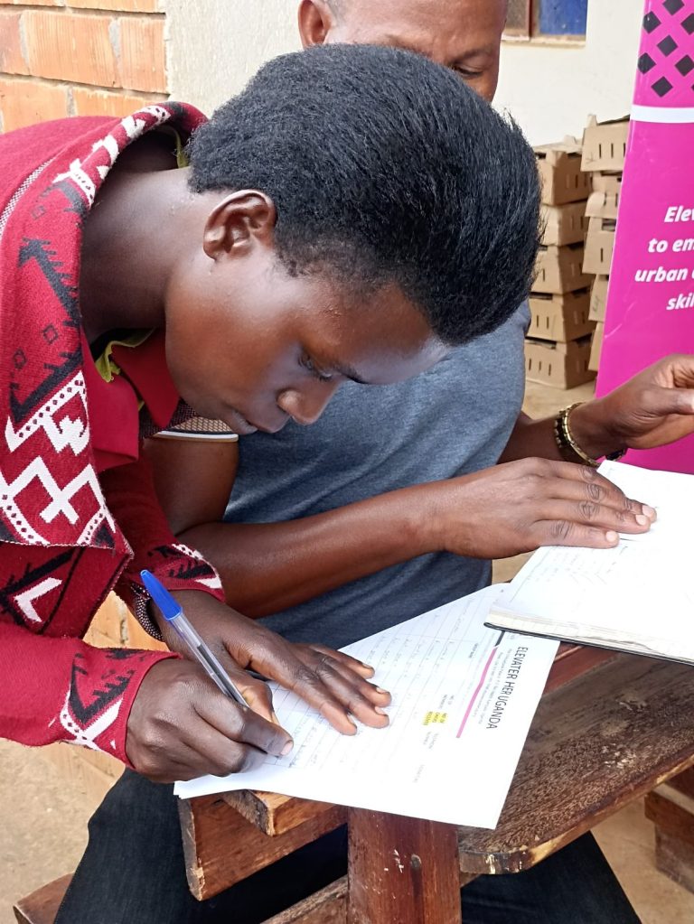 A beneficiary signs for her chicks