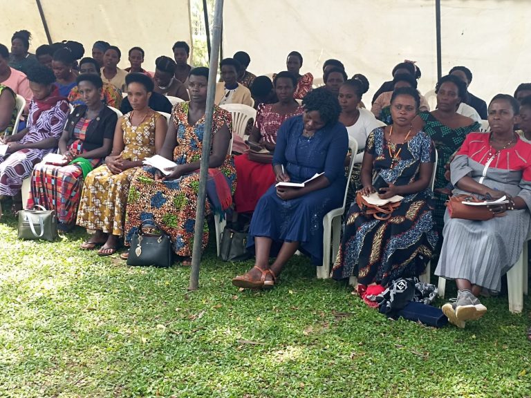 Women seated under a tent at a poultry training